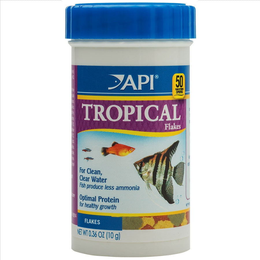 A container of API Tropical Flakes fish food with a picture of a colorful fish on the label.